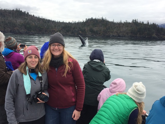 Students are photobombed by breaching humpback as they pose for the camera